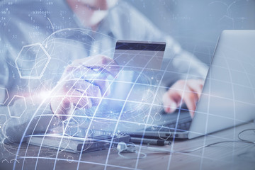 Double exposure of man hands holding a credit card and world map drawing. International Internet E-commerce and technology concept.