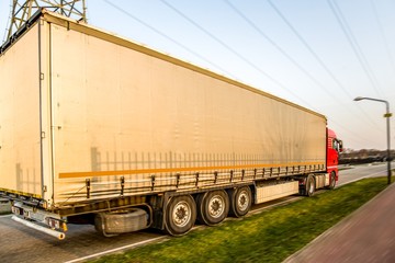 Truck moves on the road at speed, delivery of goods.