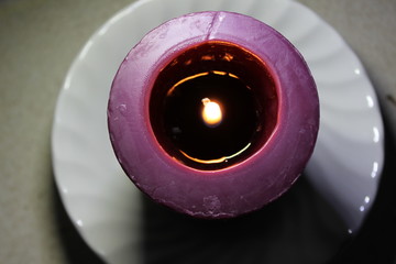 burning candle in a dish
