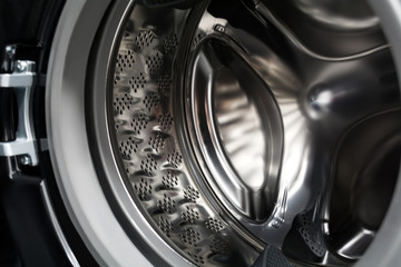 Inside a black washing machine. Inverter drum close up.