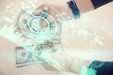 Multi exposure of financial theme drawing hologram and USA dollars bills and man hands. Business concept.