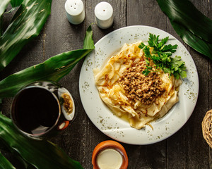 top view of khangal dish topped with minced meat and onion mixture
