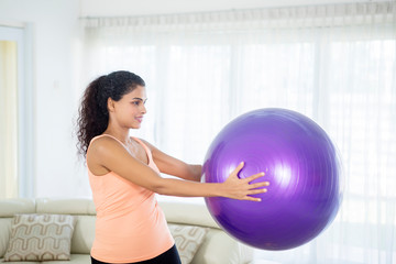 Fototapeta premium Attractive woman doing exercise with pilates ball