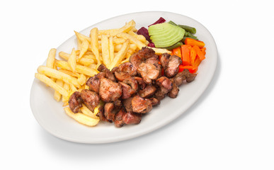 Peruvian food: roasted chicken in pieces with french fries and cooked vegetable salad served on a white plate