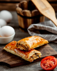 two wrapped pastry stuffed with herbs