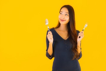 Portrait beautiful young asian woman with spoon and fork