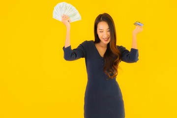 Portrait beautiful young asian woman with cash and credit card
