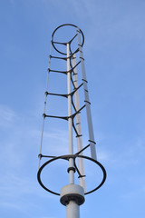 Small wind turbine in a city. Urban eco-friendly power generation. Pollution reduction by renewable energy