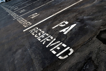 Fototapeta premium Reserved parking in a big city. Handicapped accommodation in urban area. Corporate parking spaces for employees