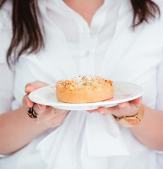 woman holding a plate with apple tart