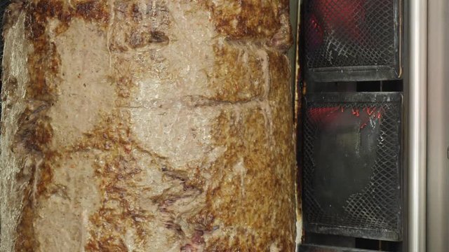 Cooking shawarma and ciabatta meat on a skewer Kebap grill. meat layers strung on a skewer