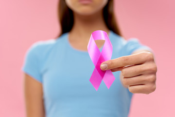 woman holding a pink ribbon