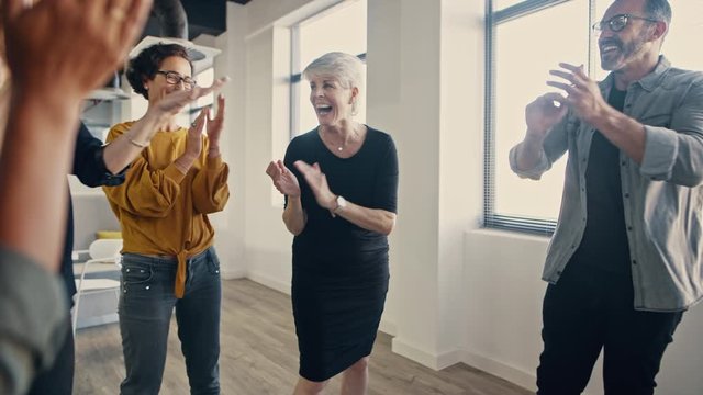 Successful business people hands stacked together and clapping. Business team showing unity.
