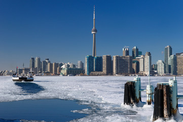 Fototapeta premium Wards Island Ferry returning to Toronto in winter on an ice covered Lake Ontario