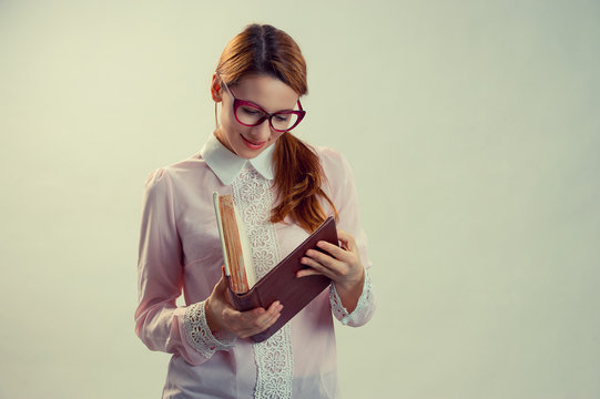 A Young Pretty Woman Between 30 And 40 Years Old With An Old Book