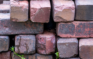 Old clay bricks stacked in a wall