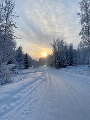 road in winter with sunset