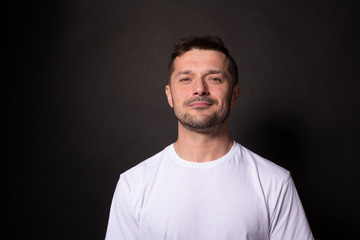 Obraz premium Handsome caucasian man confidently looks at camera. Isolated on black background
