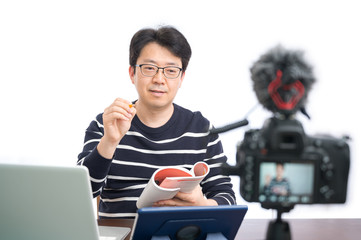 Online learning concept. An Asian middle-aged male teacher preparing to learn online.