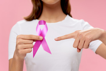 woman holding pink heart