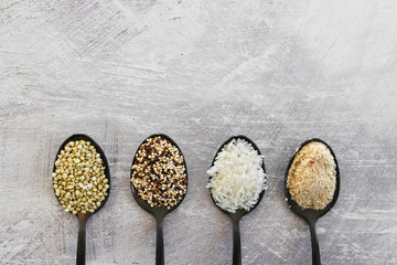plant-based diet ingredients, spoons lined up on kitchen counter with mixed grains and carbs including buckwheat quinoa rice and breadcrumbs
