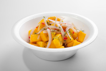 Vegetarian cebiche with mango cubes, onions and chili served on a styrofoam box