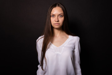 Beautiful caucasian girl with clear no makeup skin looking seriously at camera