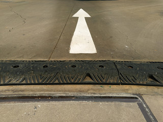 white arrow sign on the road