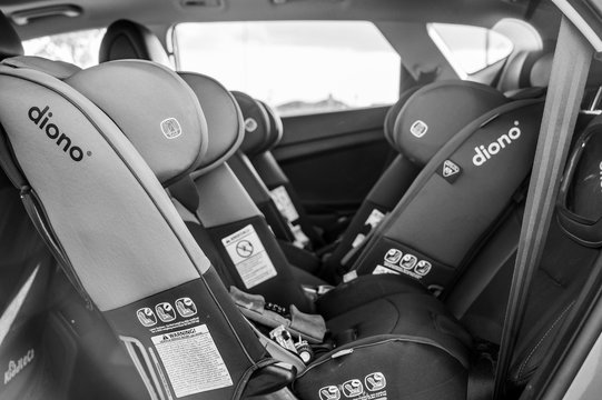 Tiffin, Iowa, USA - 7/2019: Row Of Rear And Forward Facing Diono Car Seats In Back Seat Of SUV