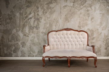 Vintage cream coloured luxury armchair isolated with clipping path in the room - obrazy, fototapety, plakaty