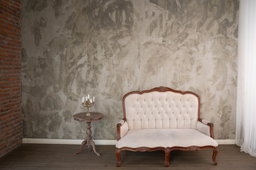 Vintage cream coloured luxury armchair isolated with clipping path in the room - obrazy, fototapety, plakaty