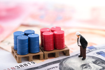Miniature people : Senior engineer standing on the banknote (US dollars and Singapore dollars) with...