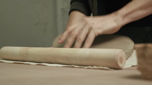 Ceramist work in the workshop.