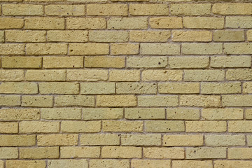 Shabby chic old yellow brick wall texture background with natural weathered appearance