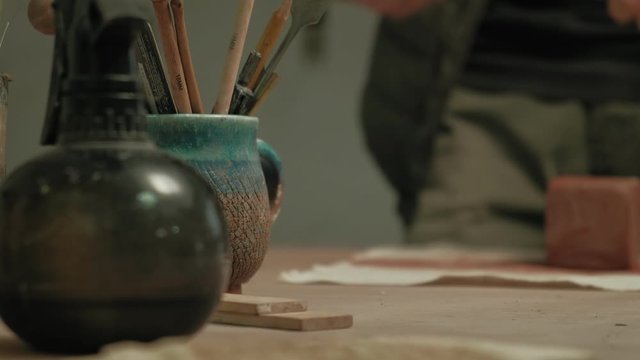 Ceramist work in the workshop.