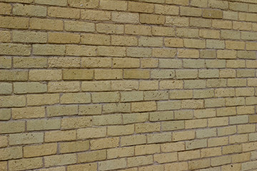 Shabby chic old yellow brick wall texture background with natural weathered appearance