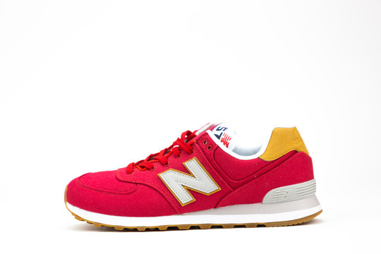 BOSTON, MA, USA, January 2019 - Red New Balance NB 574 athletic shoes on studio background. New Balance Athletics one of the world's major sports footwear manufacturers. Illustrative editorial