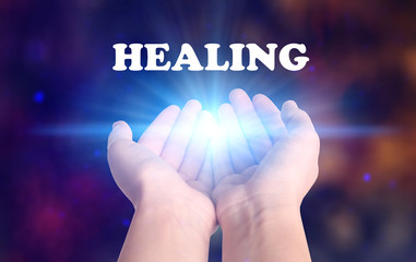 Woman holding concentrated healing energy in her hands, closeup