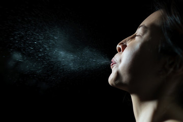 Woman coughing or sneezing. Concept of spread of the virus. Spray infection