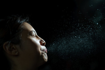 Woman coughing or sneezing. Concept of spread of the virus. Spray infection