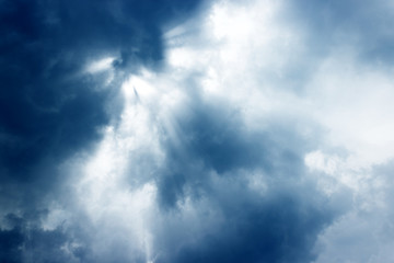 Sun rays of shining down with light god and dark clouds.