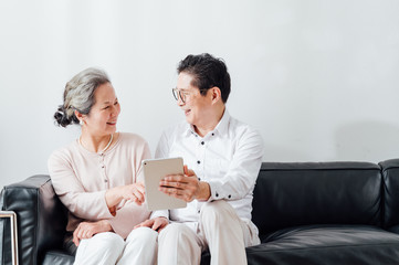 Asian aged couple using a tablet