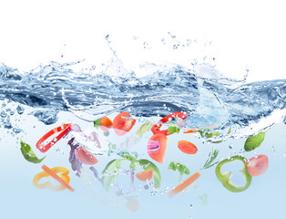Many different ingredients in water with splashes. Soup recipe
