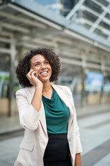 Happy businesswoman talking on the phone