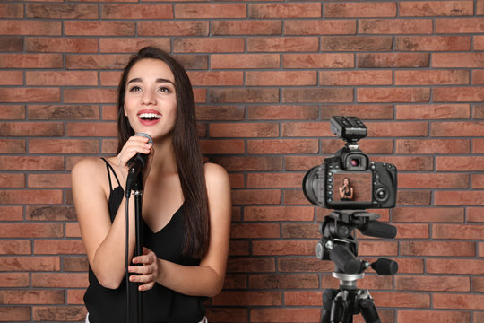 Music Teacher Recording Singing Lesson Near Brick Wall