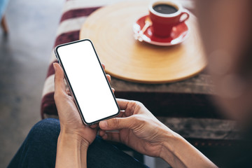cell phone Mockup image blank white screen.woman hand holding texting using mobile on desk at coffee shop.background empty space for advertise text.people contact marketing business,technology