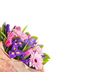 Bouquet of pink gerberas, violet irises and pink, crimson tulips in a package of paper on a white isolated background, side view. A holiday, a gift for a woman, mom, postcard, free space