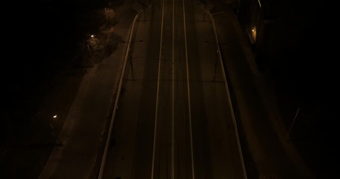 Aerial shot of the road and the bridge over the Vistula River in Warsaw. Climatic night shot of the illuminated bridge with traffic