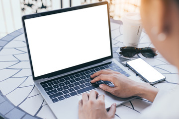 computer,cell phone mockup image blank screen with white background for advertising text,hand woman using laptop texting mobile contact business search information on desk in cafe.marketing,design