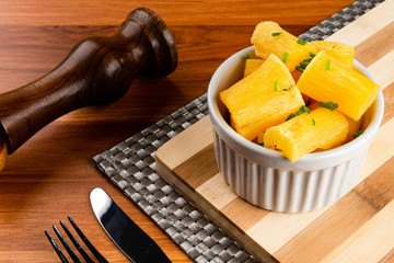 Small pieces of cassava fried in a small pot. Brazilian fried cassava concept.